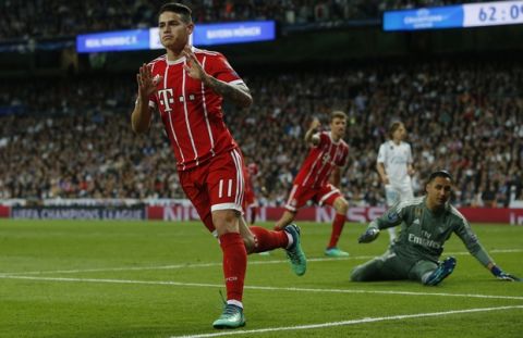 Bayern's James, left, celebrates after scoring his side's second goal during the Champions League semifinal second leg soccer match between Real Madrid and FC Bayern Munich at the Santiago Bernabeu stadium in Madrid, Spain, Tuesday, May 1, 2018. (AP Photo/Paul White)