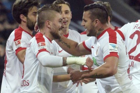Augsburg's Konstantinos Stafylidis , left, and Raul Bobadilla celebrate a goal during the Bundesliga soccer match between FC'Augsburg and RB Leipzig at the WWK-Arena in Augsburg, Germany, Friday 3 March 2017. Stefan Puchner/dpa via AP)