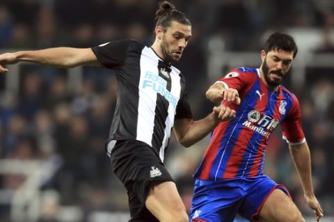 Newcastle United's Andy Carroll, left and Crystal Palace's James Tomkins battle for the ball , during the English Premier League soccer match between Newcastle United and Crystal Palace, at St James' Park, in Newcastle, England, Saturday, Dec. 21, 2019. (Owen Humphreys/PA via AP)