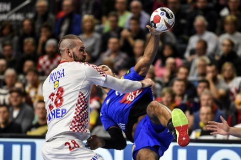 France's Melvyn Richardson, right, is stopped by Croatia's Zeljko Musa, left, during the Handball World Championship Main Round Group 1 match between France and Croatia in Cologne, Germany, Wednesday, Jan. 23, 2019. (AP Photo/Martin Meissner)