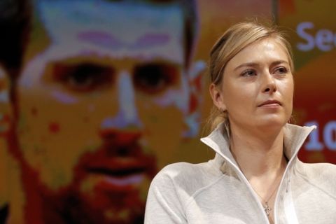 Defending champion Russia's Maria Sharapova attends the draw for the French Tennis Open, with a portrait of Serbia's Novak Djokovic on a screen behind,  at the Roland Garros stadium, Friday, May 22, 2015 in Paris. The French Open starts Sunday. (AP Photo/Francois Mori)