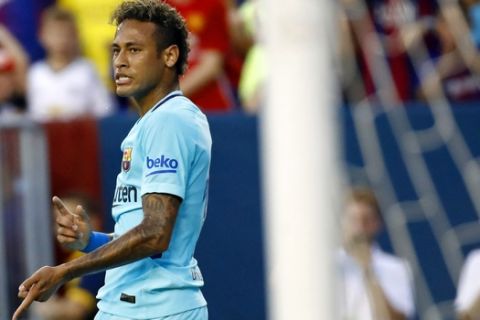Barcelona's Neymar gestures after scoring a goal during the first half of an International Champions Cup soccer match against the Manchester United, Wednesday, July 26, 2017, in Landover, Md. (AP Photo/Patrick Semansky)