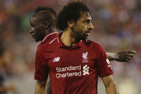 Liverpool forward Mohamed Salah, right, and Liverpool forward Sadio Mane receive instructions before a free kick during the second half of an International Champions Cup tournament soccer match against Manchester City in East Rutherford, N.J., Wednesday, July 25, 2018. (AP Photo/Steve Luciano)
