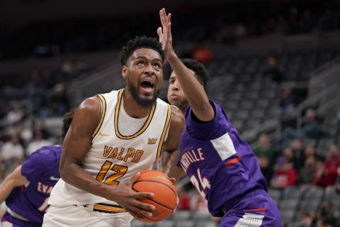 Valparaiso's Kevion Taylor (12) heads to the basket past Evansville's Preston Phillips (24) during the first half of an NCAA college basketball game in the first round of the Missouri Valley Conference tournament Thursday, March 3, 2022, in St. Louis. (AP Photo/Jeff Roberson)