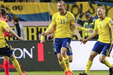 Sweden's Jakob Johansson, center, celebrates after scoring his side's first goal during the World Cup qualifying play-off first leg soccer match between Sweden and Italy, at the Friends Arena in Stockholm, Friday, Nov. 10, 2017. (AP Photo/Frank Augstein)
