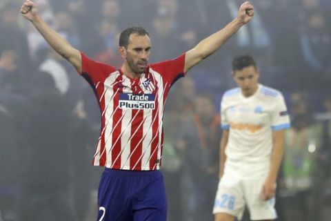 Atletico's Diego Godin celebrates his team victory over Marseille at the end of the Europa League Final soccer match between Marseille and Atletico Madrid at the Stade de Lyon in Decines, outside Lyon, France, Wednesday, May 16, 2018. Striker Antoine Griezmann punished sloppy Marseille with two expertly-taken goals as Atletico Madrid won the Europa League for the third time with a resounding 3-0 victory in Wednesday's final.. (AP Photo/Laurent Cipriani)