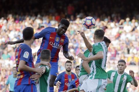 FC Barcelona's Samuel Umtiti, center left, heads for the ball during a Spanish La Liga soccer match between FC Barcelona and Betis at the Camp Nou in Barcelona, Spain, Saturday, Aug. 20, 2016. (AP Photo/Manu Fernandez)