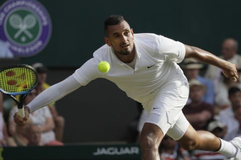Australia's Nick Kyrgios plays a shot back to Spain's Rafael Nadal in a Men's singles match during day four of the Wimbledon Tennis Championships in London, Thursday, July 4, 2019. (AP Photo/Kirsty Wigglesworth)