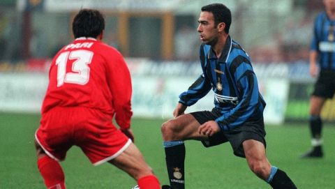 Inter Milan's French midfielder Youri Djorkaeff, right, faces Piacenza's Fausto Pari, during their Italian first division soccer game, at the Milan San Siro stadium, Saturday, October 12, 1996. Inter Milan won 2-0.(AP Photo/Carlo Fumagalli)