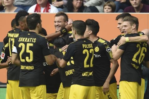 Dortmund players celebrate the opening goal during the German Bundesliga soccer match between FC Augsburg and Borussia Dortmund in Augsburg, southern Germany, Saturday. Sept. 30, 2017.  (Andreas Gebert/dpa via AP)