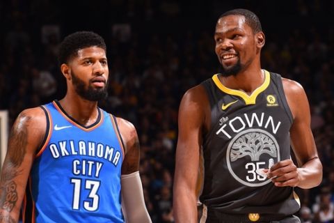 OAKLAND, CA - FEBRUARY 6:  Kevin Durant #35 of the Golden State Warriors and Paul George #13 of the Oklahoma City Thunder on February 6, 2018 at ORACLE Arena in Oakland, California. NOTE TO USER: User expressly acknowledges and agrees that, by downloading and or using this photograph, user is consenting to the terms and conditions of Getty Images License Agreement. Mandatory Copyright Notice: Copyright 2018 NBAE (Photo by Noah Graham/NBAE via Getty Images)