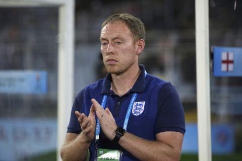 England's soccer coach Steve Cooper applauds before the start of the FIFA U-17 World Cup final match between England and Spain in Kolkata, India, Saturday, Oct. 28, 2017. (AP Photo/Anupam Nath)