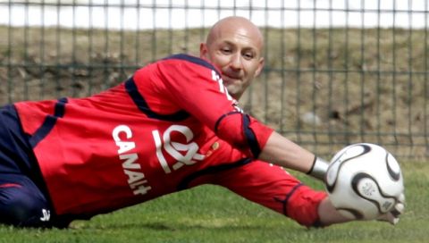 France's Fabien Barthez catches the ball during a training session with the French soccer team in Tignes, French Alps, Tuesday, May 23, 2006. France will play against Switzerland, Korea Republic and Togo in Group G during the upcoming soccer World Cup in Germany. (AP Photo/Christophe Ena)