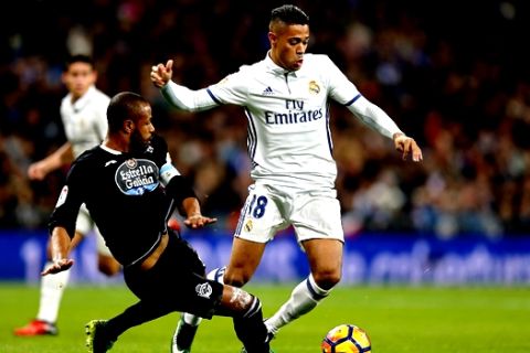 Real Madrid's Mariano Diaz, right, vies for the ball with Deportivo's Sidnei Da Silva during a Spanish La Liga soccer match between Real Madrid and Deportivo Coruna at the Santiago Bernabeu stadium in Madrid, Saturday, Dec. 10, 2016. Mariano scored once in Real Madrid's 3-2 victory. (AP Photo/Francisco Seco)