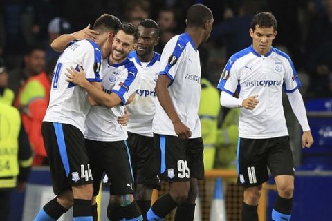 Apollon Limassol's Hector Yuste, left, celebrates scoring his side's second goal of the game against Everton, during the Europa League, Group E soccer match at Goodison Park, Liverpool, England, Thursday Sept. 28, 2017. (Peter Byrne/PA via AP)