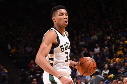 OAKLAND, CA - MARCH 18: Giannis Antetokounmpo #34 of the Milwaukee Bucks handles the ball against the Golden State Warriors on March 18, 2017 at ORACLE Arena in Oakland, California. NOTE TO USER: User expressly acknowledges and agrees that, by downloading and or using this photograph, user is consenting to the terms and conditions of Getty Images License Agreement. Mandatory Copyright Notice: Copyright 2017 NBAE (Photo by Noah Graham/NBAE via Getty Images)
