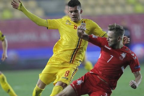 Lithuania's Arturas Zulpa challenges for the ball with Romania's Ianis Hagi during the UEFA Nations League soccer match between Romania and Lithuania at the Ilie Oana stadium in Ploiesti, Romania, Saturday, Nov. 17, 2018. (AP Photo/Vadim Ghirda)