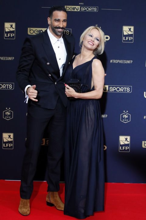 Soccer player Adil Rami and US actress Pamela Anderson pose as they arrive at the UNFP (Union of French Professional Footballers) ceremony, in Paris, France, Sunday, May 19, 2019. (AP Photo/Francois Mori)