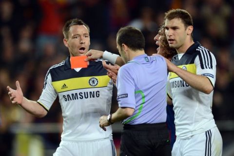 Chelsea's defender John Terry (L) receives a red card from Turkish referee Cuneyt Cakir during the UEFA Champions League second leg semi-final football match Barcelona against Chelsea at the Cam Nou stadium in Barcelona on April 24, 2012. AFP PHOTO / ADRIAN DENNIS (Photo credit should read ADRIAN DENNIS/AFP/Getty Images)