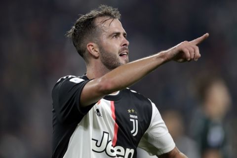 Juventus' Miralem Pjanic celebrates after scoring his side's second goal during a Serie A soccer match between Juventus and Bologna, at the Allianz stadium in Turin, Italy, Saturday, Oct.19, 2019. (AP Photo/Luca Bruno)
