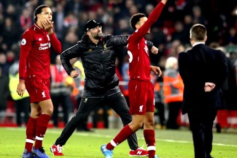 Liverpool coach Juergen Klopp, center, celebrates at the end of the English Premier League soccer match between Liverpool and Newcastle at Anfield Stadium, in Liverpool, England, Wednesday, Dec. 26, 2018. (AP Photo/Jon Super)