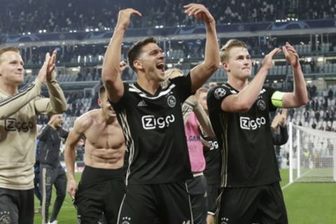 Ajax' players celebrate at the end of the Champions League, quarterfinal, second leg soccer match between Juventus and Ajax, at the Allianz stadium in Turin, Italy, Tuesday, April 16, 2019. Ajax won 2-1 and advances to the semifinal on a 3-2 aggregate. (AP Photo/Luca Bruno)