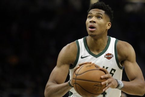 Milwaukee Bucks' Giannis Antetokounmpo shoots a free throw during the second half of an NBA basketball game against the Detroit Pistons Wednesday, Dec. 5, 2018, in Milwaukee. (AP Photo/Aaron Gash)
