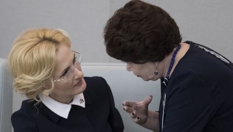 Deputy speaker of the State Duma Irina Yarovaya, left, and a member of the Communist Party faction Tamara Pletnyova talk before voting in the State Duma, the Lower House of the Russian Parliament in Moscow, Russia, Wednesday, Dec. 6, 2017. The lower chamber of the Russian parliament has voted to bar Voice of America and Radio Free Europe/Radio Liberty from accessing it in the latest tit-for-tat between Russia and the U.S. over government-funded media outlets. (AP Photo/Pavel Golovkin)