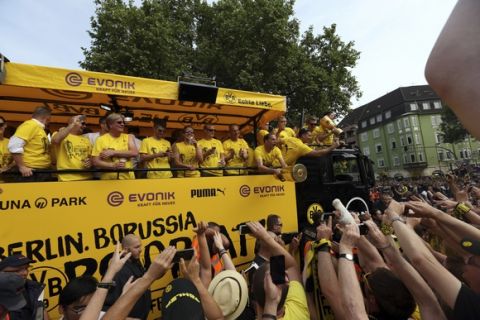 The truck with Borussia Dortmund players arrives at the Borsigplatz place in Dortmund, Germany, Sunday, May28, 2017, after they won the German soccer cup on Saturday against Eintracht Frankfurt in Berlin. (Friso Gentsch/dpa via AP)