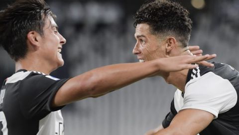 Juventus' Cristiano Ronaldo, right, celebrates with teammate Paulo Dybala after scoring a goal during the Italian Serie A soccer match between Juventus and Lazio at the Allianz stadium in Turin, Italy, Monday, July 20, 2020. (Marco Alpozzi/LaPresse via AP)