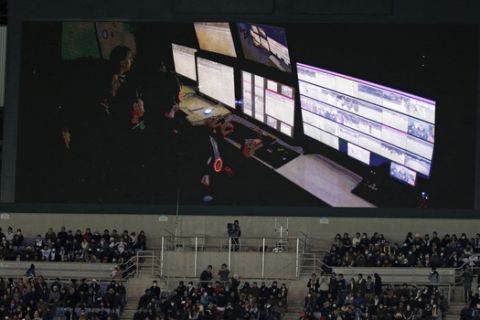 A stadium screen shows VAR (video assistant referee) review after Real Madrid's Cristiano Ronaldo scores a goal in the second half of the semifinal against Club America at the FIFA Club World Cup soccer tournament Thursday, Dec. 15, 2016 in Yokohama, near Tokyo.  Referee Enrique Caceres appeared to ask for confirmation from his video assistant referee that there was no offside. The Paraguayan official then decided that the goal stood without appearing to view a video himself. Real Madrid won the match, 2-0. (AP Photo/Shuji Kajiyama)