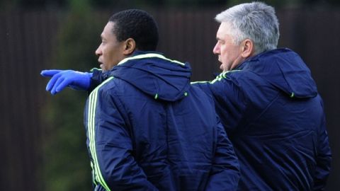 Chelsea manager Carlo Ancelotti, right, talks to his new assistant  Michael Emenalo at the Cobham training ground, Cobham, England, Monday, Nov. 22, 2010. Chelsea will face MSK Zilila in a Champions League group F soccer match at the Stamford Bridge stadium, London, Tuesday. (AP Photo/Tom Hevezi)