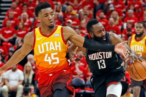 Utah Jazz guard Donovan Mitchell (45) defends against Houston Rockets guard James Harden (13) as he drives up court in the first half during an NBA basketball game Saturday, April 20, 2019, in Salt Lake City. (AP Photo/Rick Bowmer)