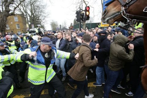 Police control soccer fans prior to the Tottenham Hotspur v Millwall, English FA Cup quarter final game at White Hart Lane, Tottenham, London Sunday March 12, 2017. (Yui Mok//PA via AP)