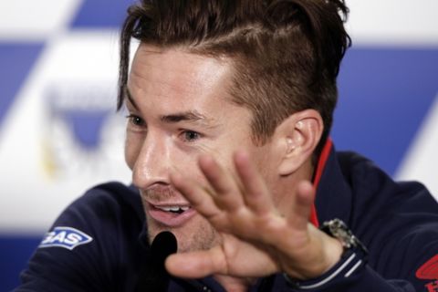 FILE - In this Thursday, Oct. 20, 2016 file photo, Honda MotoGP rider Nicky Hayden holds up his hand during an official pre-race press conference ahead of the Australian Motorcycle Grand Prix at Phillip Island, Australia. American motorcycle racer Nicky Hayden has been hit by a car while out training on his bicycle, Wednesday, May 17, 2017. The Superbike World Championship says the incident occurred along the Rimini coast, Italy, Wednesday.  The 35-year-old Hayden who won the MotoGP title in 2006 was transported to a local hospital for treatment. (AP Photo/Rob Griffith, File)