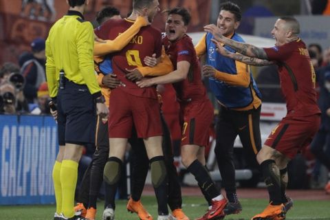 Roma's Edin Dzeko, 3rd from left, celebrates with teammates after scoring his side's opening goalduring a Champions League round of 16 second-leg soccer match between Roma and Shakhtar Donetsk, at the Rome Olympic stadium, Tuesday, March 13, 2018. (AP Photo/Gregorio Borgia)