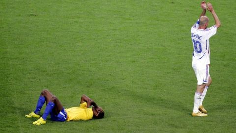 Brazil's Ze Roberto, left, lies on the pitch as France's Zinedine Zidane applauds after the Brazil vs. France World Cup quarter final soccer match in Frankfurt, Germany, Saturday, July 1, 2006. France won the match 1-0. (AP Photo/ Michael Probst) ** MOBILE/PDA USAGE OUT **