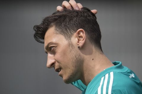 Mesut Oezil scratches his head during a training session of the German team at the 2018 soccer World Cup in Vatutinki near Moscow, Russia, Thursday, June 14, 2018. (AP Photo/Michael Probst)