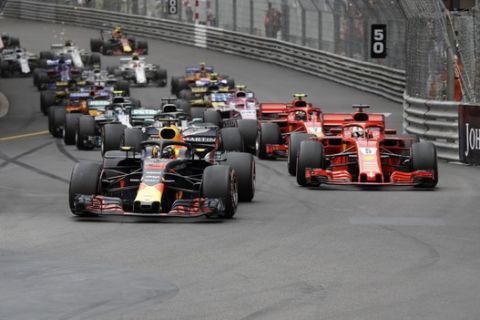 Red Bull driver Daniel Ricciardo of Australia, left, leads at the start and followed by Ferrari driver Sebastian Vettel of Germany, right and Mercedes driver Lewis Hamilton of Britain during the Formula One race, at the Monaco racetrack, in Monaco, Sunday, May 27, 2018. (AP Photo/Luca Bruno)