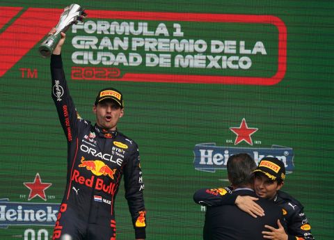Red Bull driver Max Verstappen, left, of the Netherlands, celebrates after winning the Formula One Mexico Grand Prix on the podium of the Hermanos Rodriguez racetrack as his teammate and third place finisher Sergio Perez, of Mexico, is congratulated by Carlos Slim Domit, in Mexico City, Sunday, Oct. 30, 2022. (AP Photo/Fernando Llano)