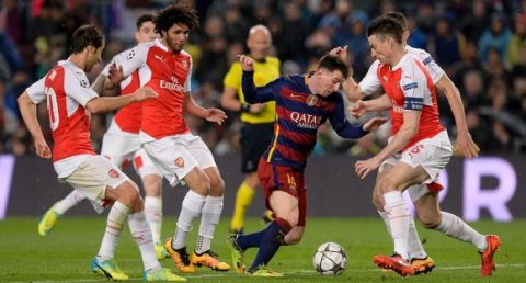 "Arsenal's players vie with Barcelona's Argentinian forward Lionel Messi (C) during the UEFA Champions League Round of 16 second leg football match FC Barcelona vs Arsenal FC at the Camp Nou stadium in Barcelona on March 16, 2016.  / AFP / JOSEP LAGO        (Photo credit should read JOSEP LAGO/AFP/Getty Images)"