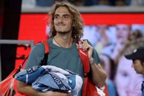Greece's Stefanos Tsitsipas smiles as he leaves the court after defeating Georgia's Nikoloz Basilashvili during their third round match at the Australian Open tennis championships in Melbourne, Australia, Friday, Jan. 18, 2019. (AP Photo/Mark Schiefelbein)