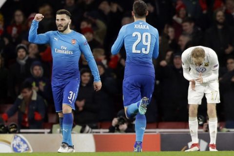 Arsenal's Sead Kolasinac, right, celebrates after scoring his side's first goal during the Europa League Round of 32, second leg soccer match between Arsenal and Ostersunds FK at the Emirates Stadium in London, Thursday, Feb. 22, 2018. (AP Photo/Alastair Grant)