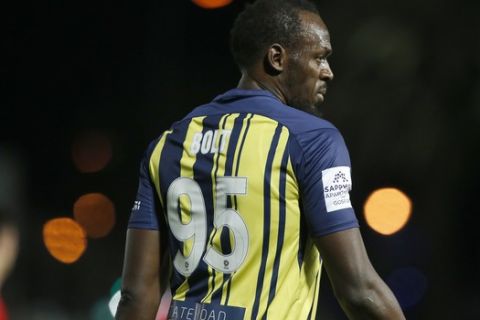 Usain Bolt participates in a friendly trial match between the Central Coast Mariners and the Central Coast Select in Gosford, Australia, Friday, Aug. 31, 2018. Bolt, who holds the world records for the 100- and 200-meter sprints and is an eight-time Olympic gold medalist, is hoping to earn a contract with the Mariners for the 2018-19 season in Australia's top-flight competition. (AP Photo/Steve Christo)