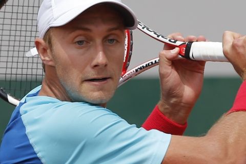Canada's Peter Polansky returns the ball during the first round match of the French Open tennis tournament against Tomas Berdych of the Czech Republic at the Roland Garros stadium, in Paris, France, Sunday, May 25, 2014. (AP Photo/Michel Spingler)
