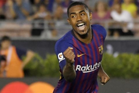 CORRECTS PLAYER'S NAME TO MALCOM INSTEAD OF CARLES ALENA - Barcelona midfielder Malcom celebrates his game-winning penalty kick during the shootout in an International Champions Cup tournament soccer match against Tottenham on Saturday, July 28, 2018, in Pasadena, Calif. Barcelona won on penalty kicks after the match was tied 2-2 in regulation. (AP Photo/Mark J. Terrill)