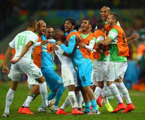 CURITIBA, BRAZIL - JUNE 26: Algeria celebrate their first goal scored by Islam Slimani (not pictured) during the 2014 FIFA World Cup Brazil Group H match between Algeria and Russia at Arena da Baixada on June 26, 2014 in Curitiba, Brazil.  (Photo by Clive Rose/Getty Images)