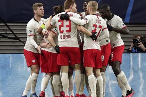 Leipzig's Marcel Sabitzer is celebrated by his team after he scored his second goal during the Champions League round of 16, 2nd leg soccer match between RB Leipzig and Tottenham Hotspur in Leipzig, Germany, Tuesday, March 10, 2020. (AP Photo/Michael Sohn)