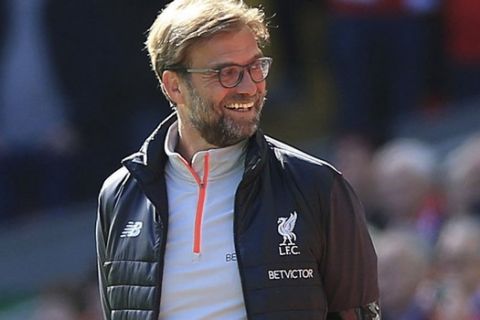 Liverpool manager Jurgen Klopp smiles, during the English Premier League soccer match between Liverpool and Everton, at Anfield, in Liverpool, England, Saturday April 1, 2017. (Peter Byrne/PA via AP)