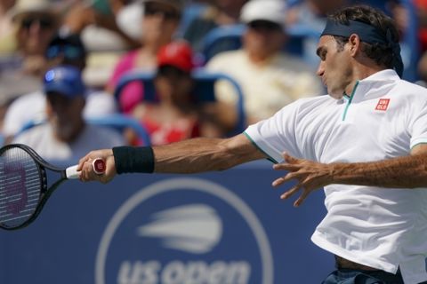 Roger Federer, of Switzerland, returns to Andrey Rublev, of Russa, during the quarterfinals of the Western & Southern Open tennis tournament, Thursday, Aug. 15, 2019, in Mason, Ohio. (AP Photo/John Minchillo)
